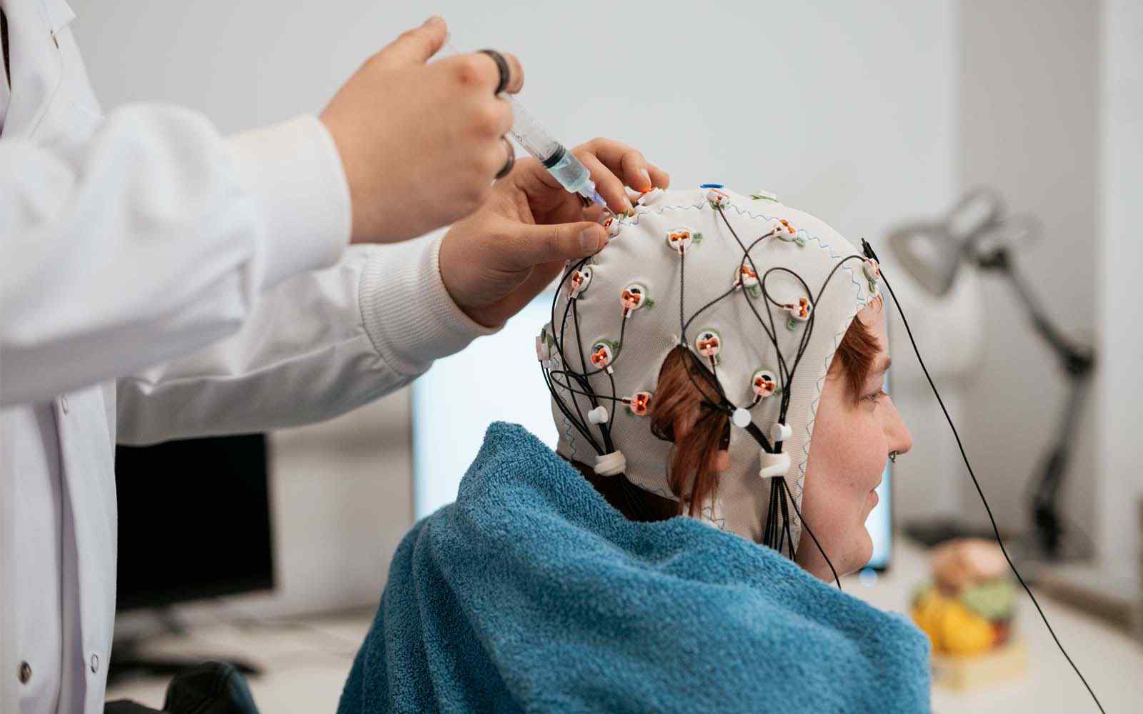 Psychology student wearing an electroencephalogram cap