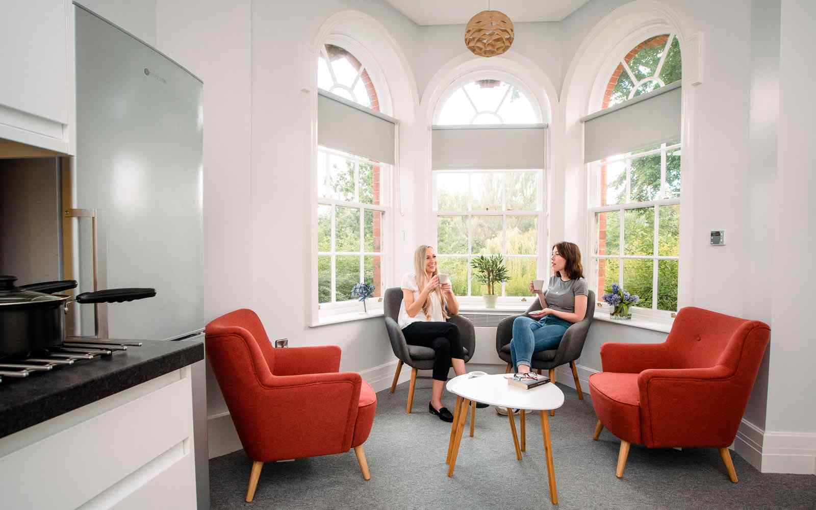 Two students relaxing in The Grange accommodation