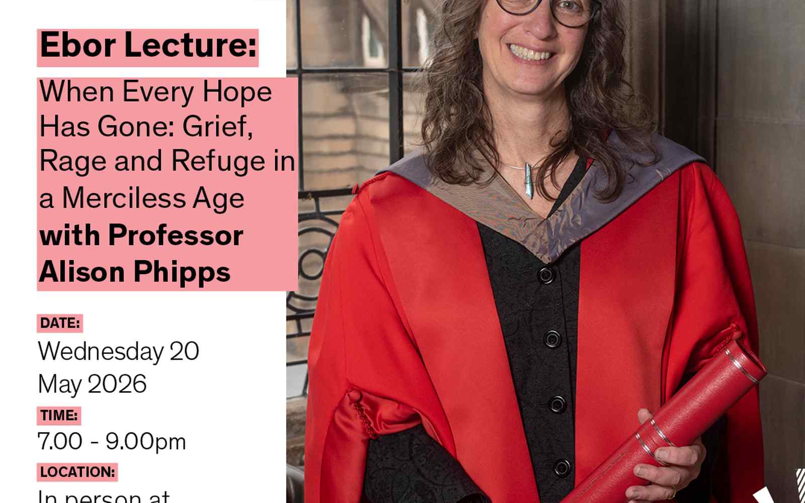 Alison Phipps wears a red Graduation robe and smiles at the camera