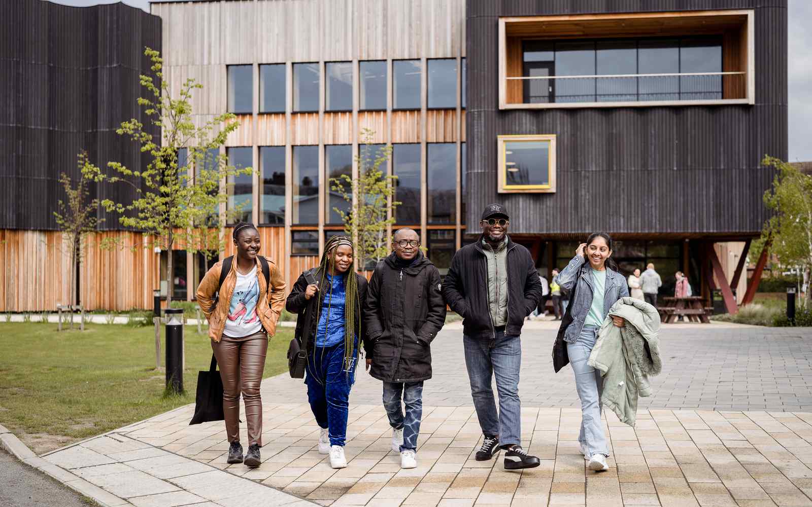Five students walking infront of the Creative Centre.