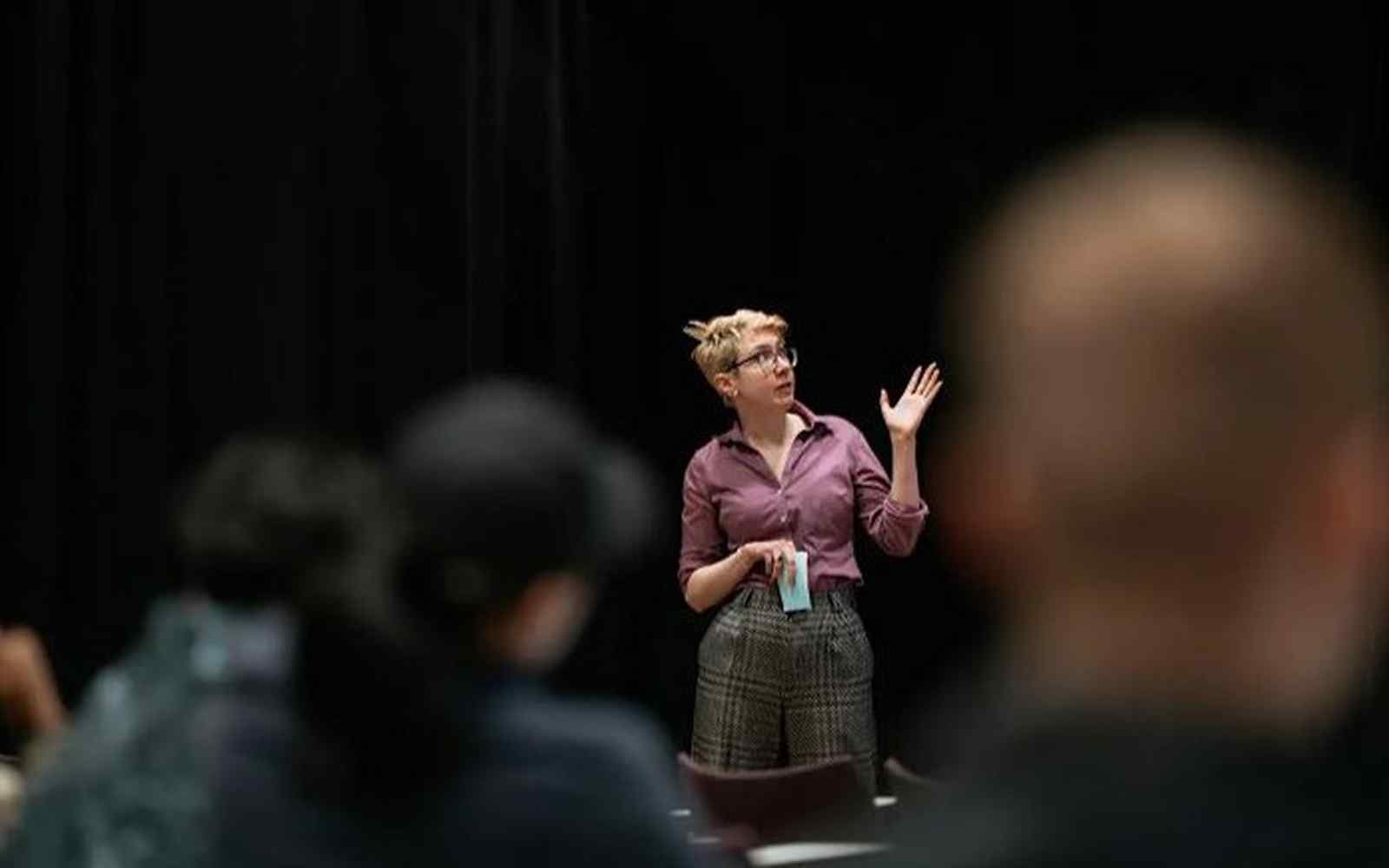 An attendee stood in front of a screening presenting at Innovation Supper