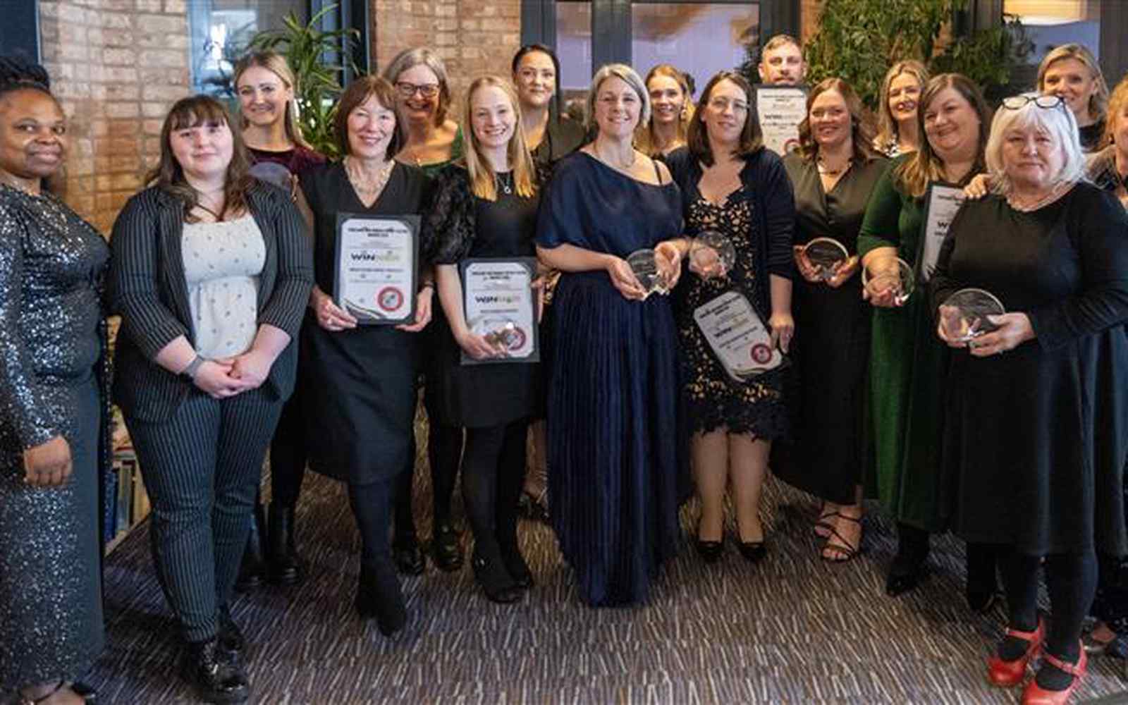 A group of people stood together holding their awards and certificates which they have been present at the previous Yorkshire and Humber Feeding Awards.