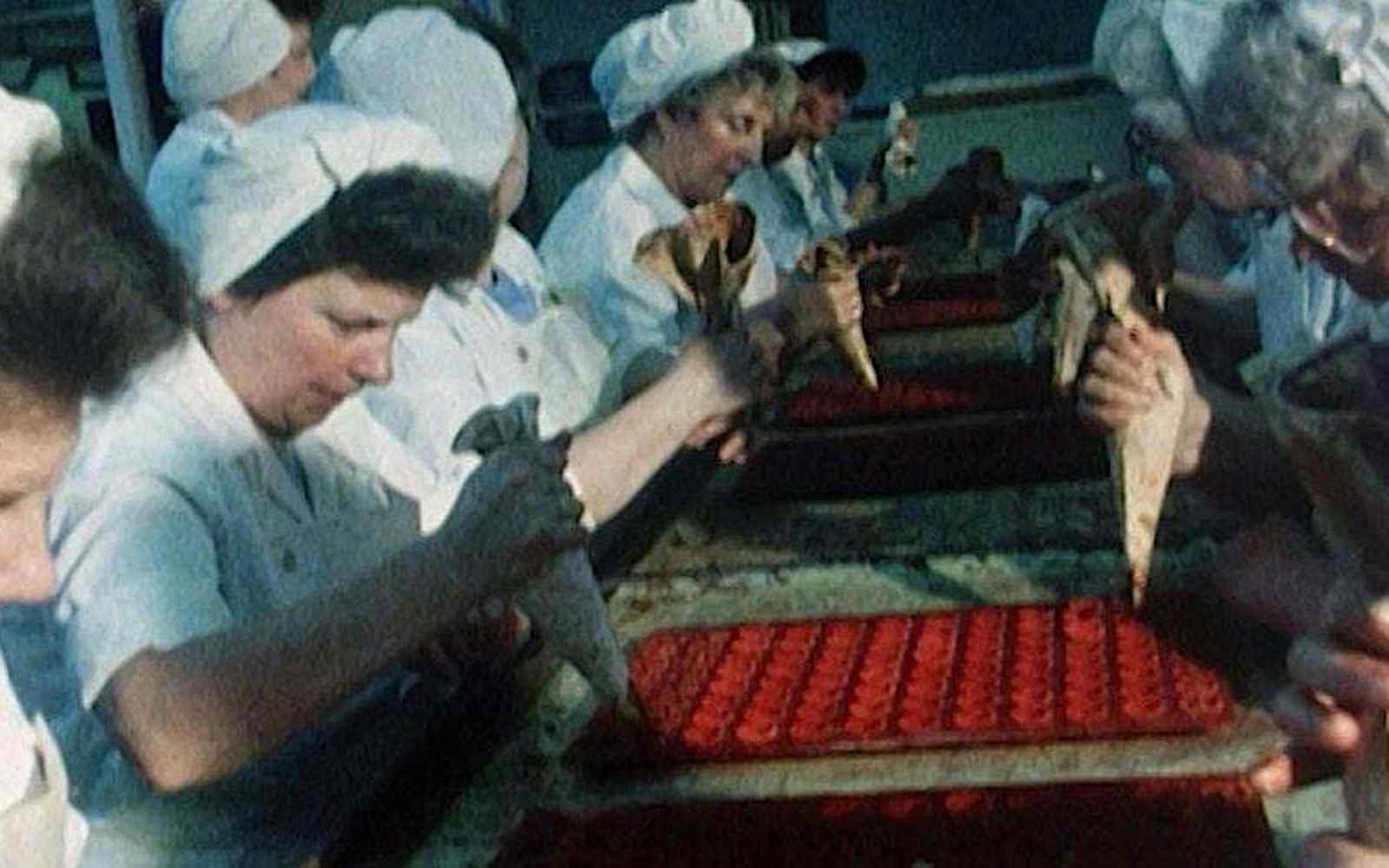 women piping chocolate into moulds