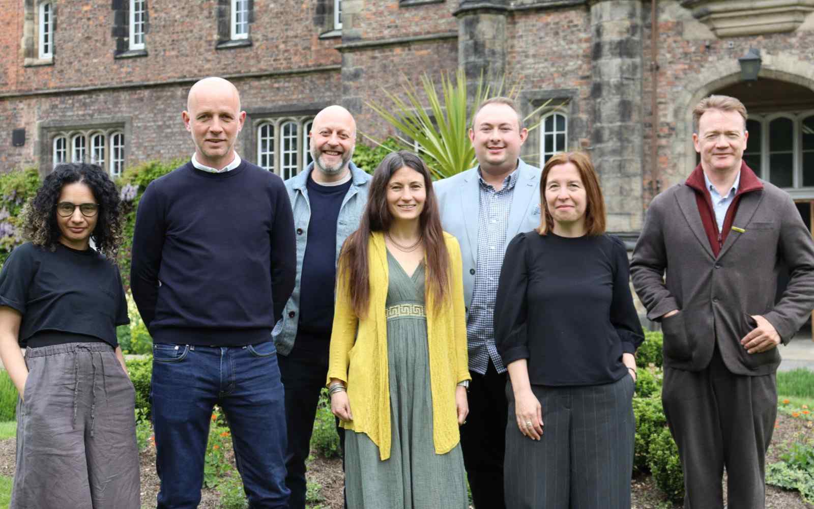 A group of people pictured in front of York St John University's main entrance