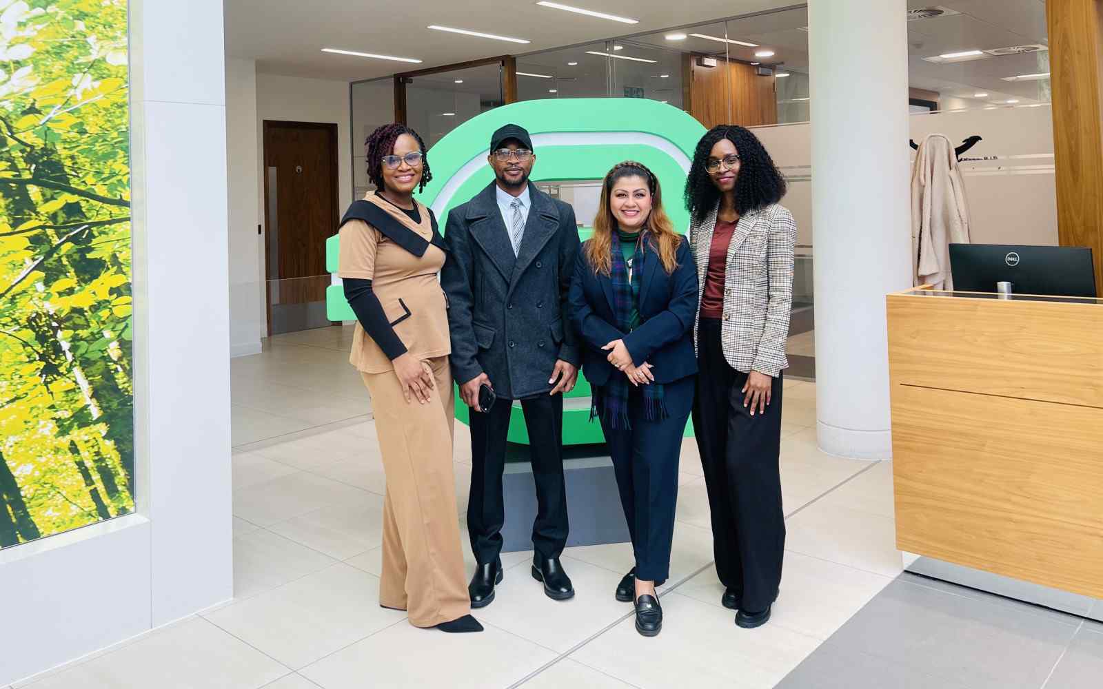 4 people stood in a line inside