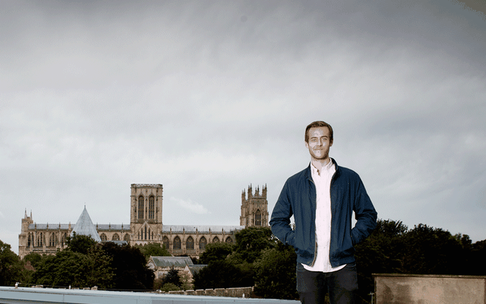 student on top of building, York Minster in b/g 