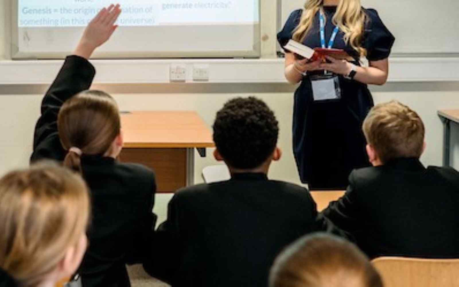 A trainee teacher and pupils in a classroom setting