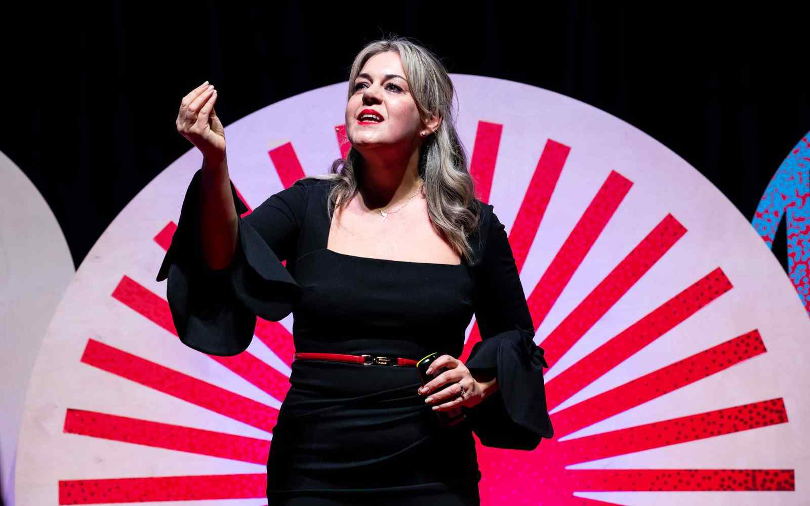 A woman delivering a presentation on stage