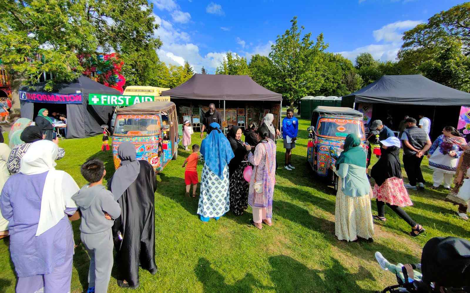 People browsing stalls at an outdoor community festival