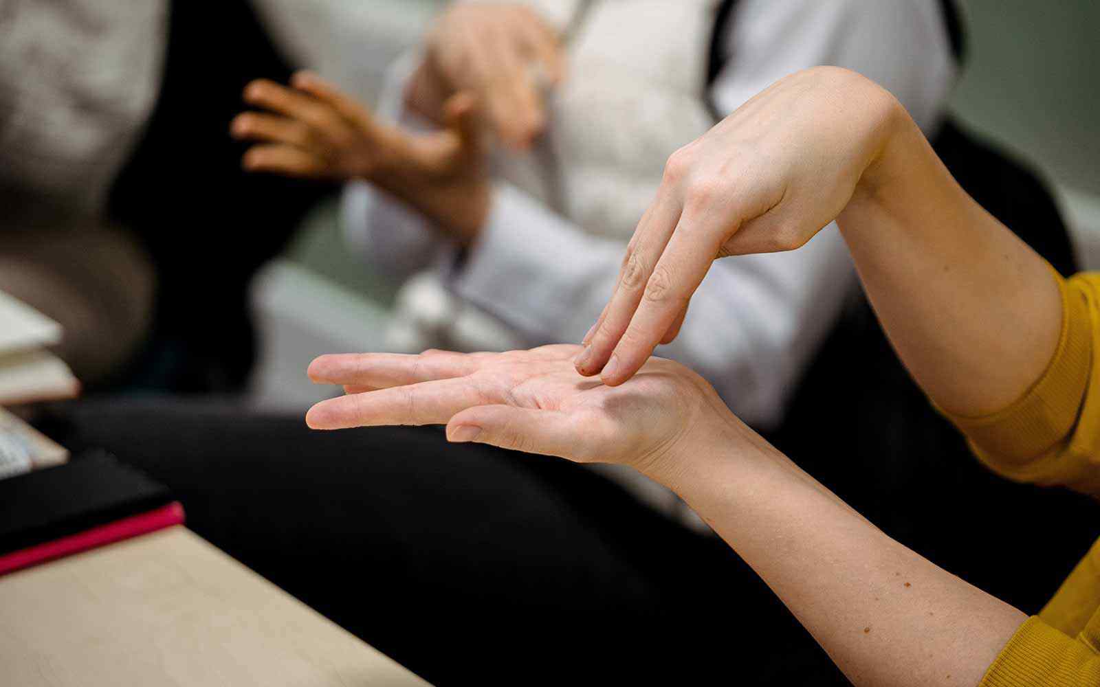 Close up of hands speaking sign language.