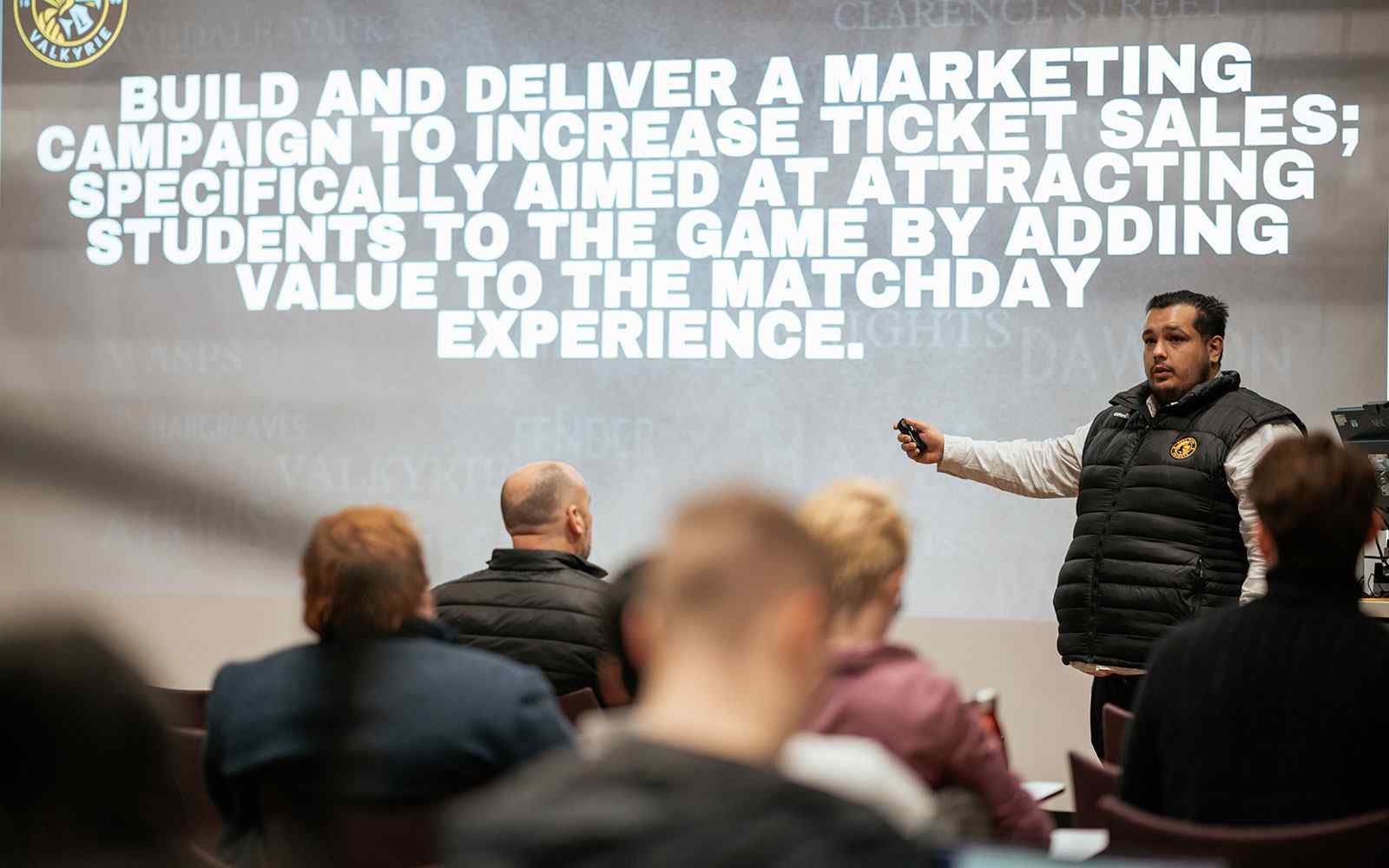 Presenter sharing brief on creating a marketing campaign on screen