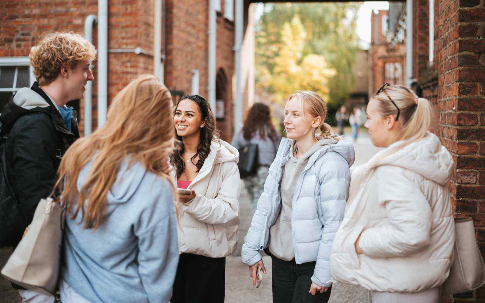 Students on the York St John University campus during Autumn.