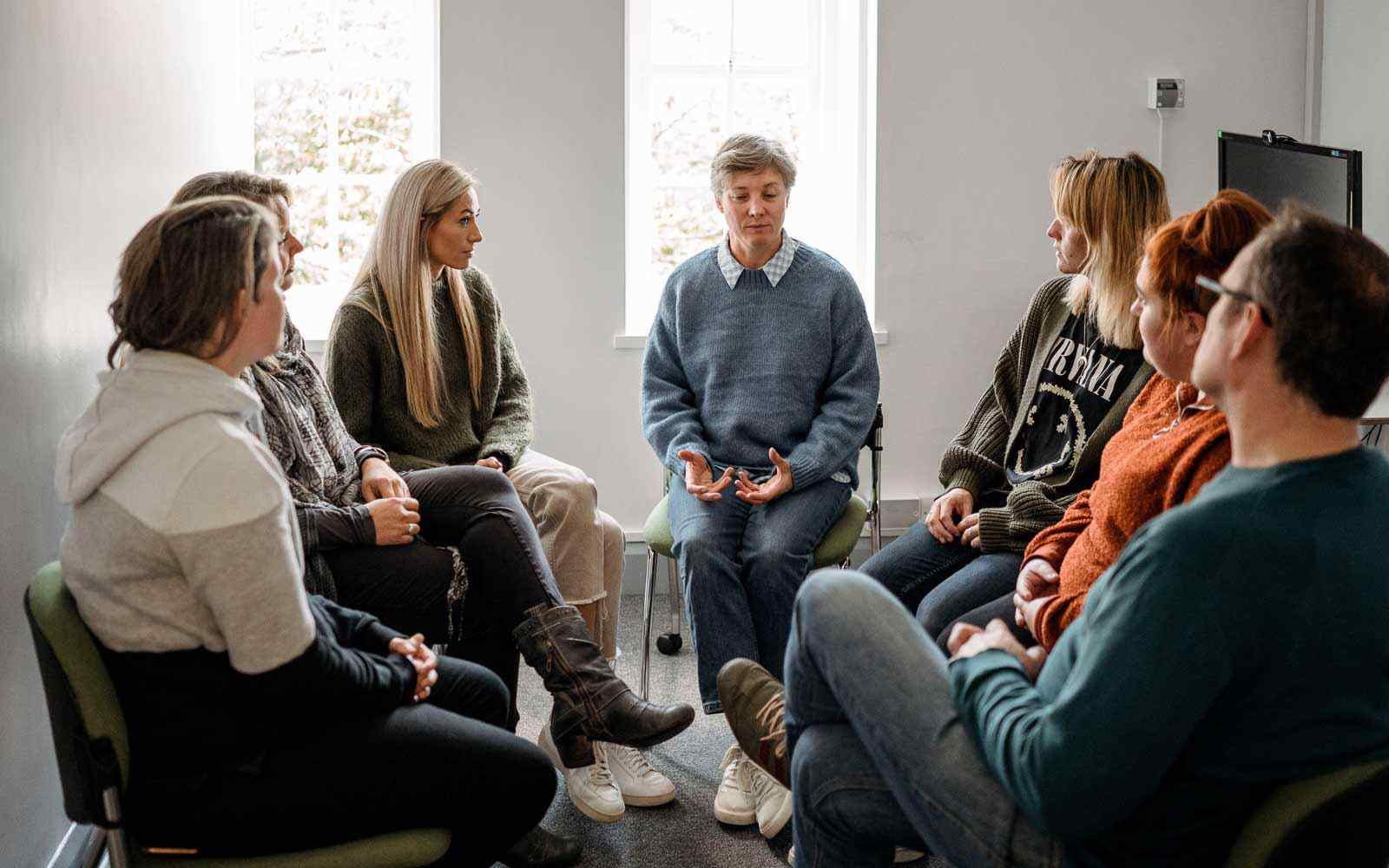 Group of people sitting together and talking.