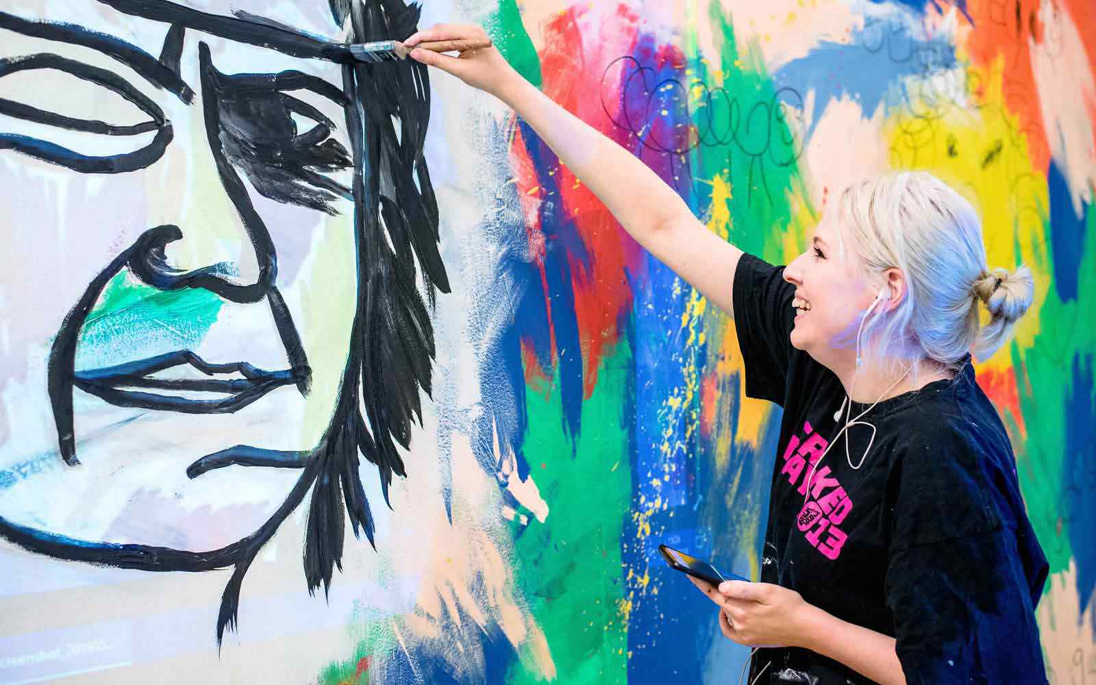Student painting wall canvas