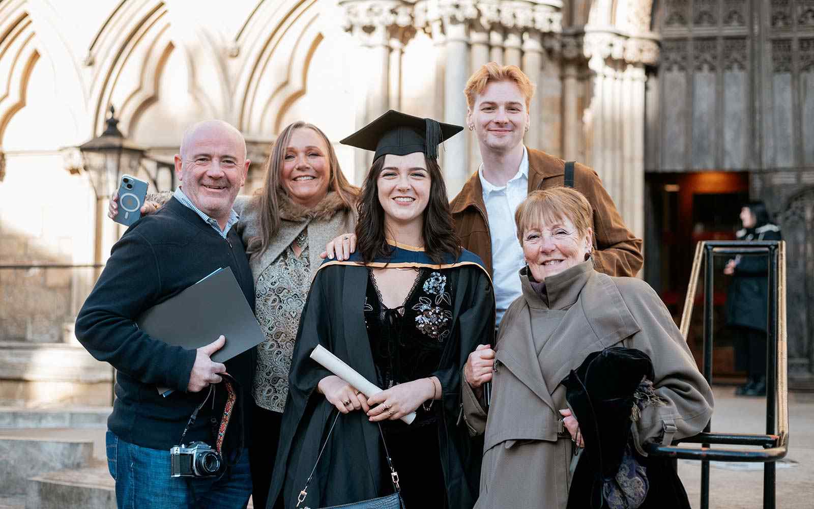 Graduate surrounded by proud family