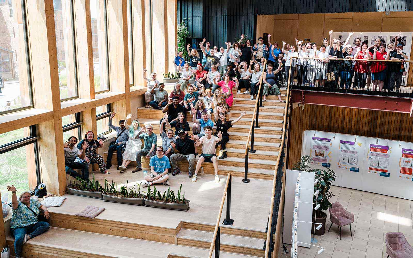 Festival attendees sat on Creative Centre steps