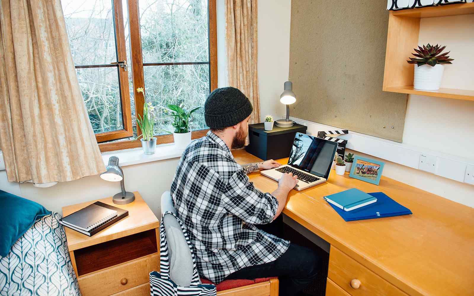 A student working on a laptop from accommodation at Limes Court