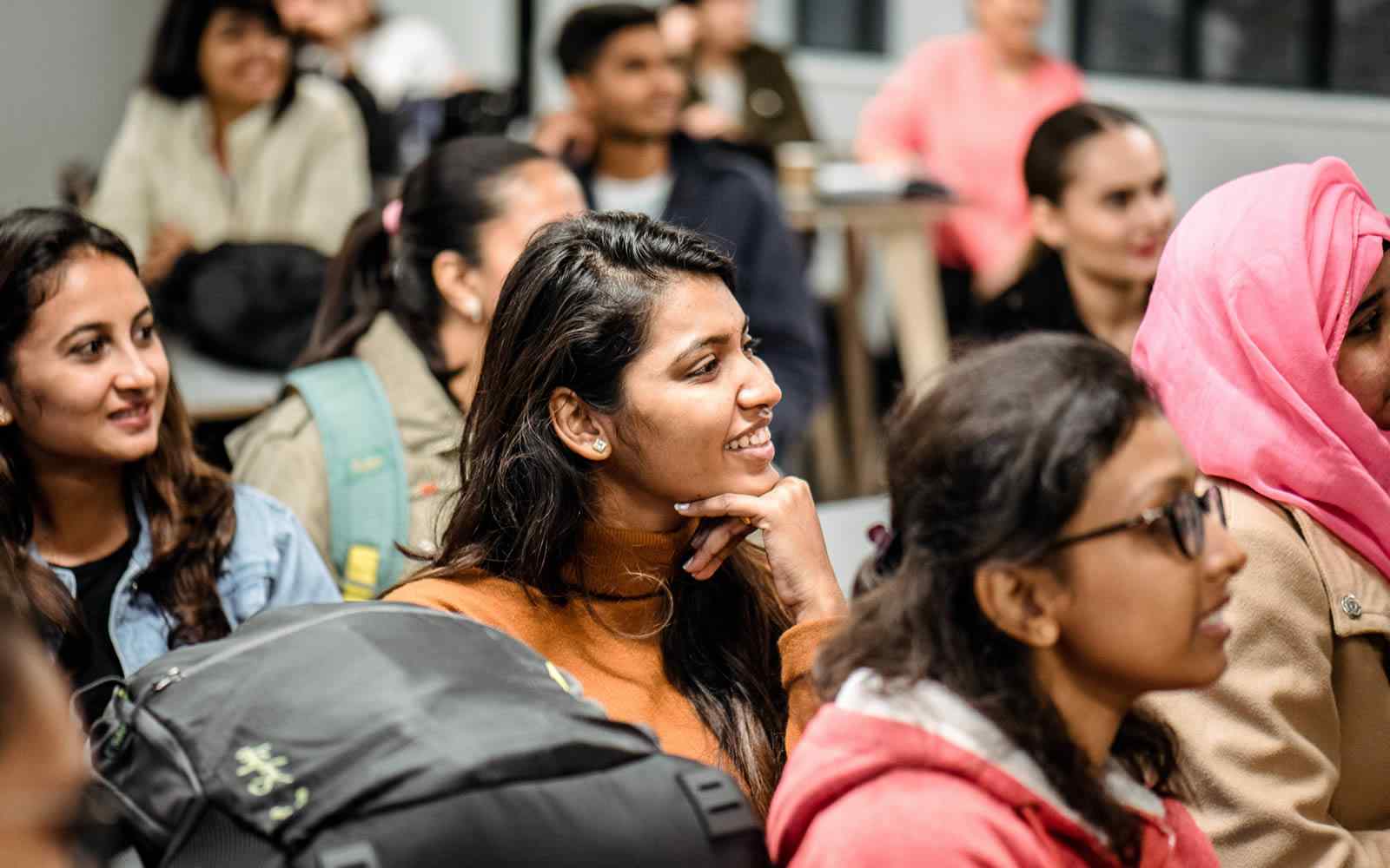 Students listening to a tutor at the YSJ London campus.
