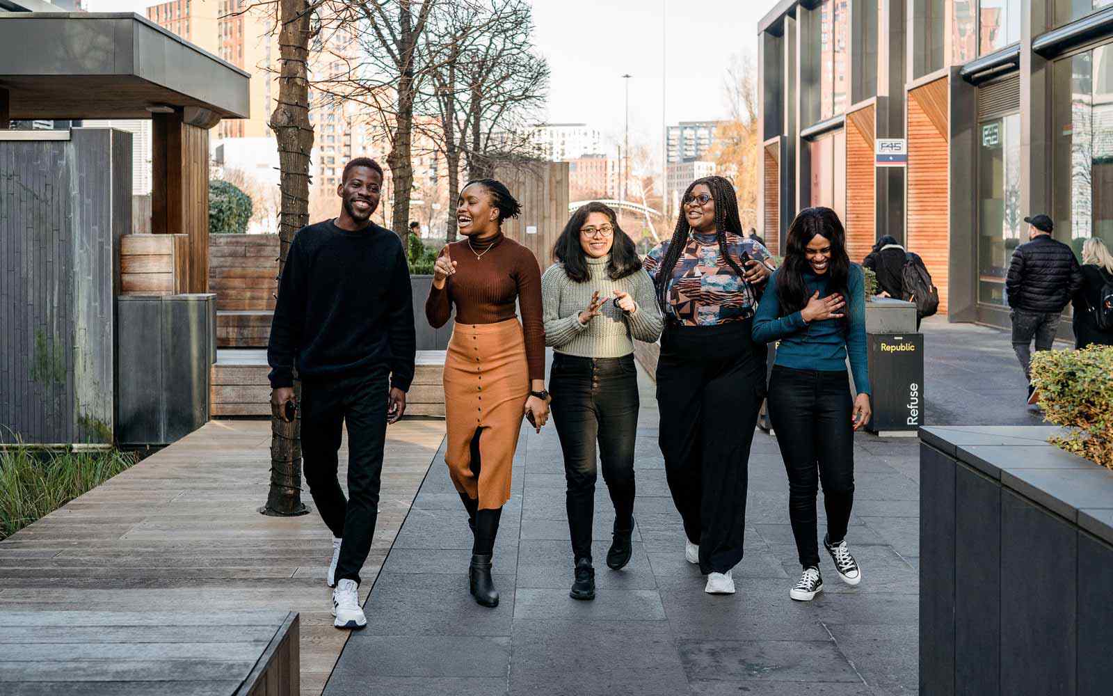 Students walking together at YSJ London campus.