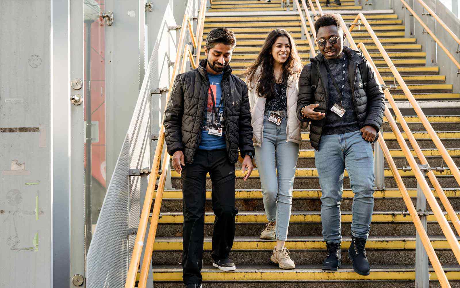 Students walking down stairs at YSJ London Campus.