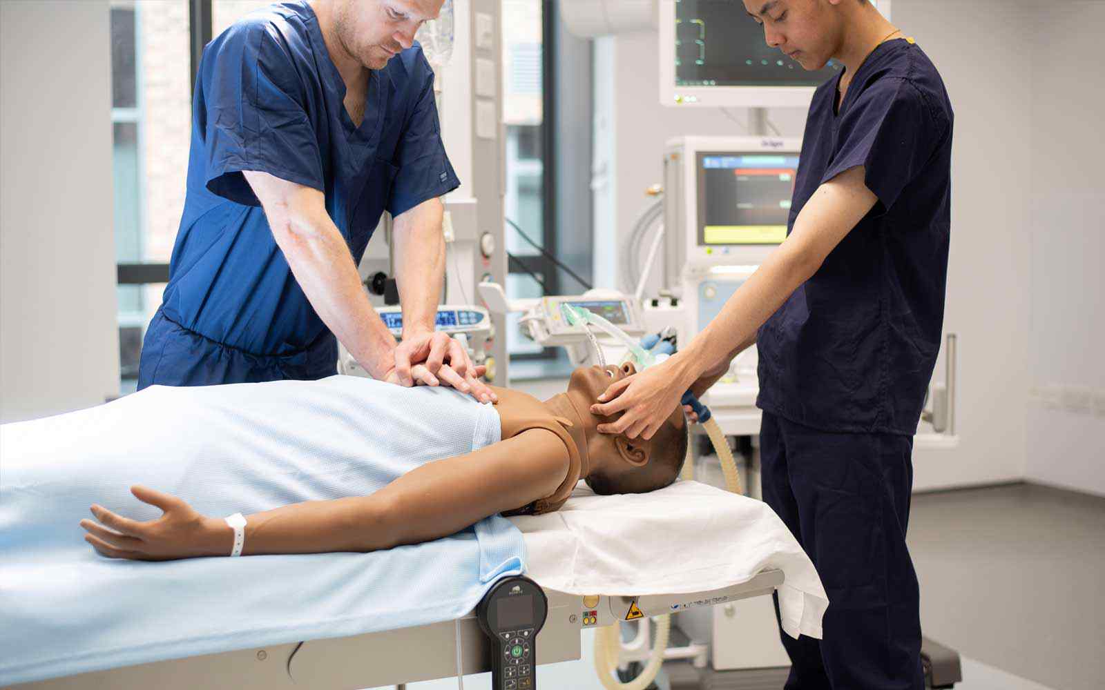 Two ODP students work on a medial mannequin.