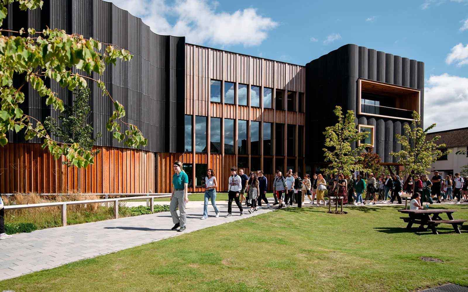 A student ambassador leads visitors on an Open Day tour.