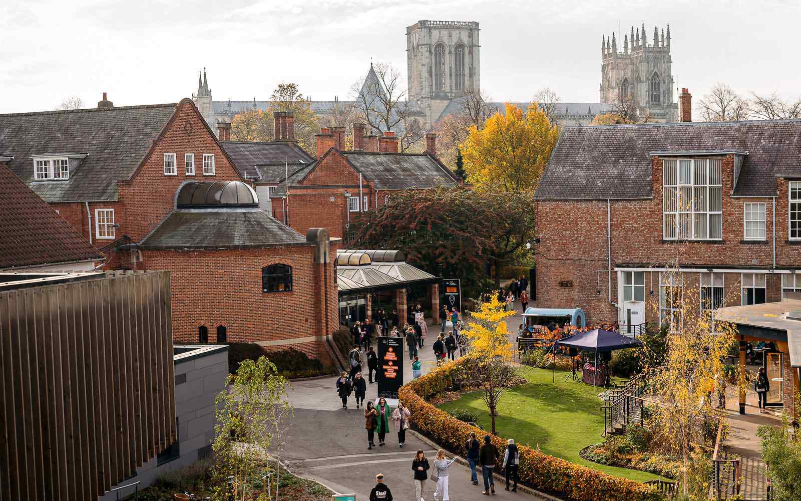 View of visitors at a campus event with York Minster in the background.