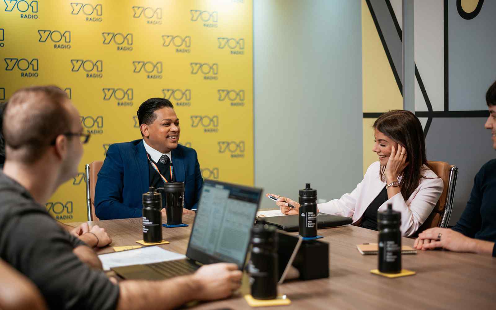 Business students sat around table at YO1 radio studio