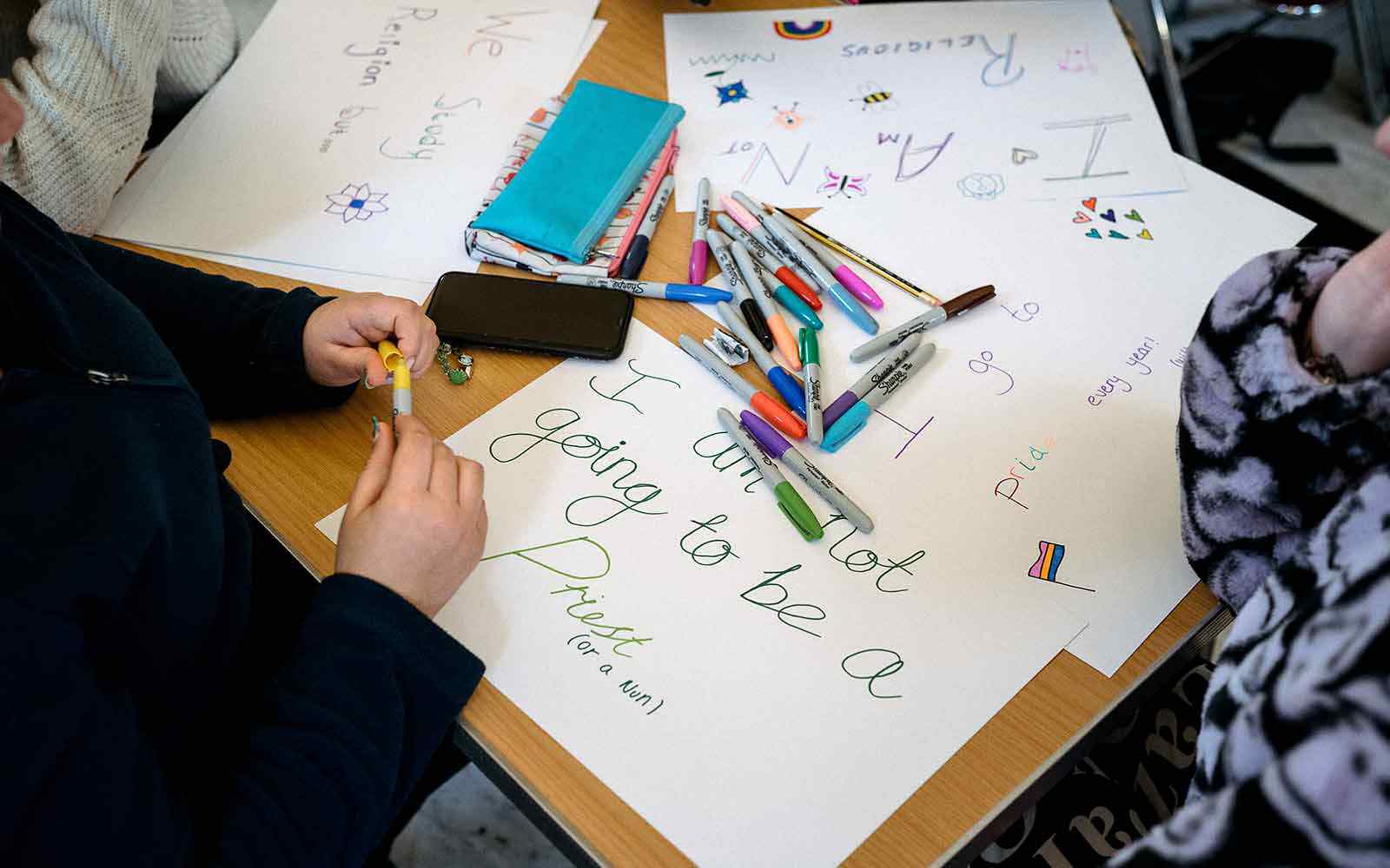 Students writing signs.