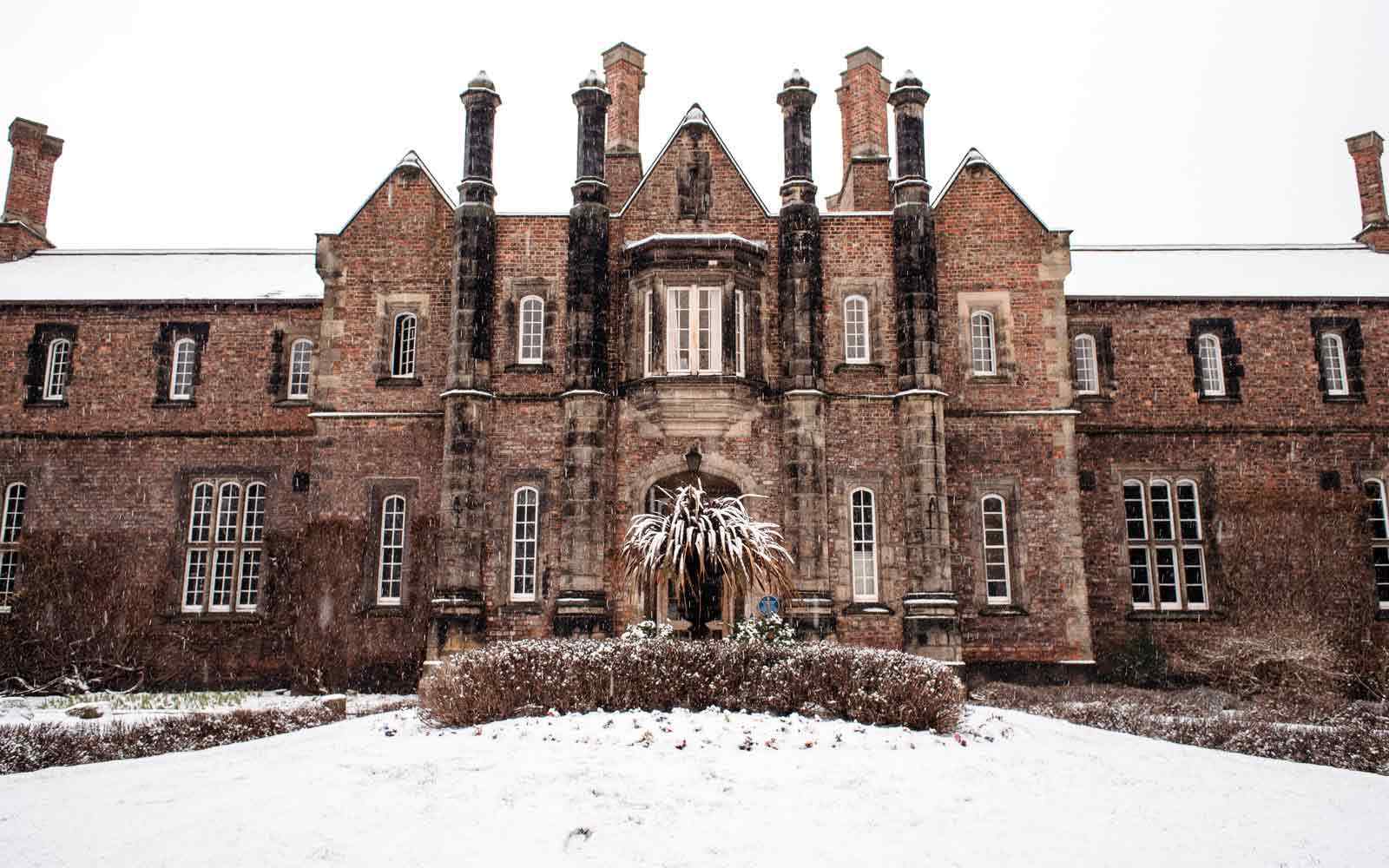 Historic Lord Mayor's Walk buildings on the York St John campus, covered in snow.
