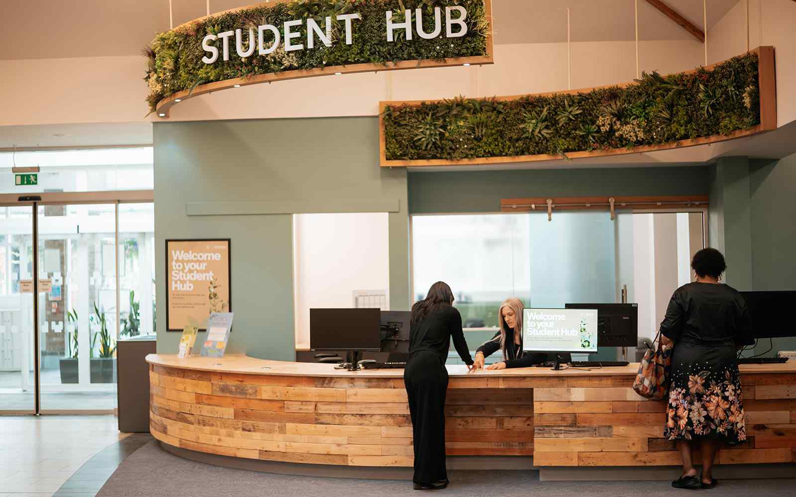 Student asking for support at the Student Hub help desk in Holgate