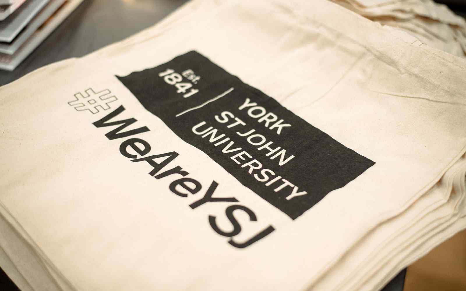 Tote bag with York St John logo and #WeAreYSJ hashtag.