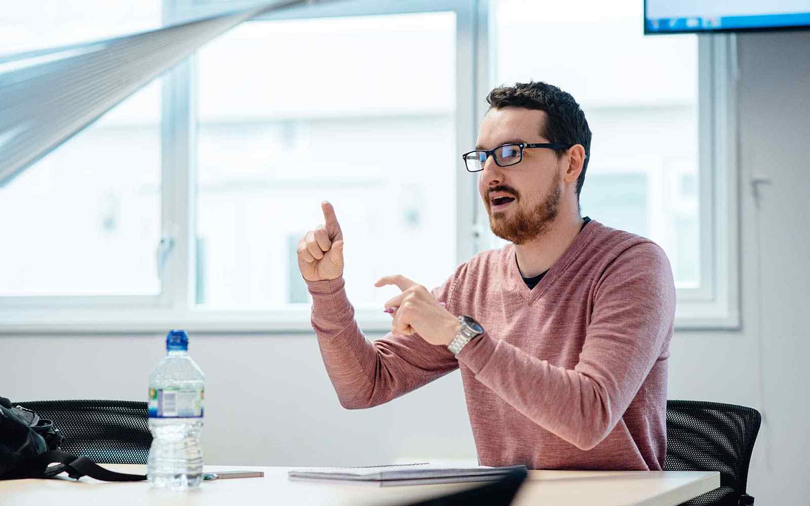 A tutor talking in a class.
