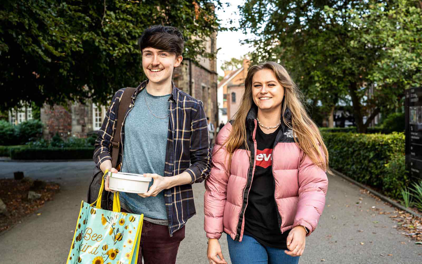 Two students walking through campus.