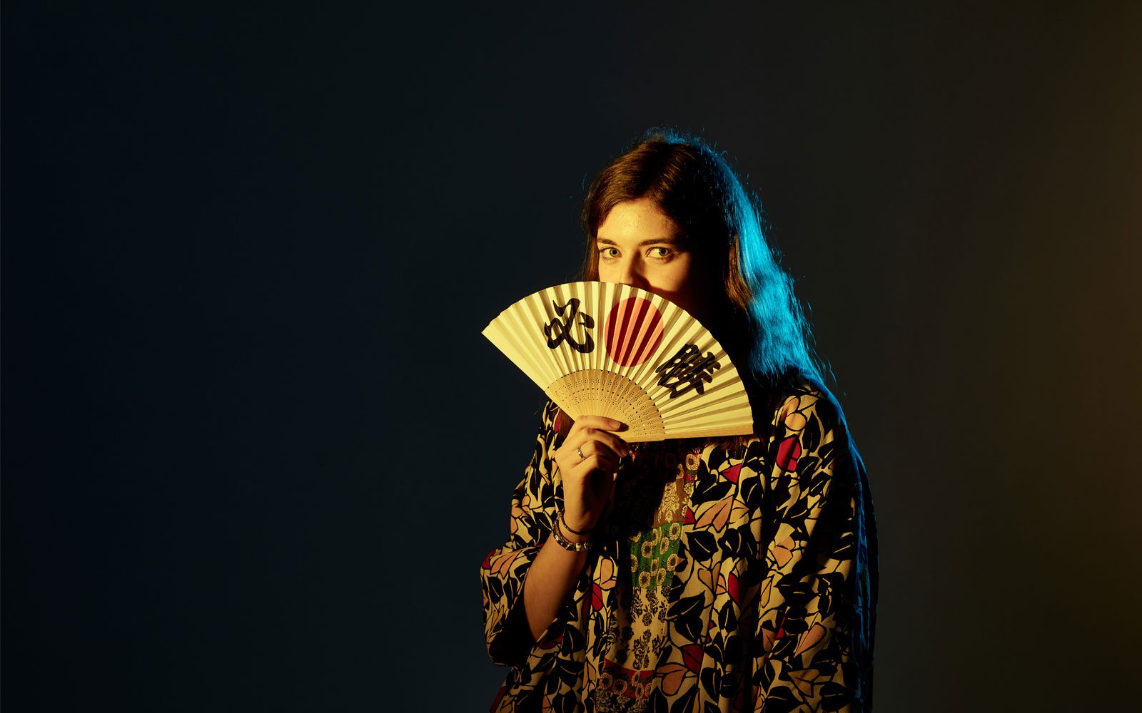 Student in darkness with fan