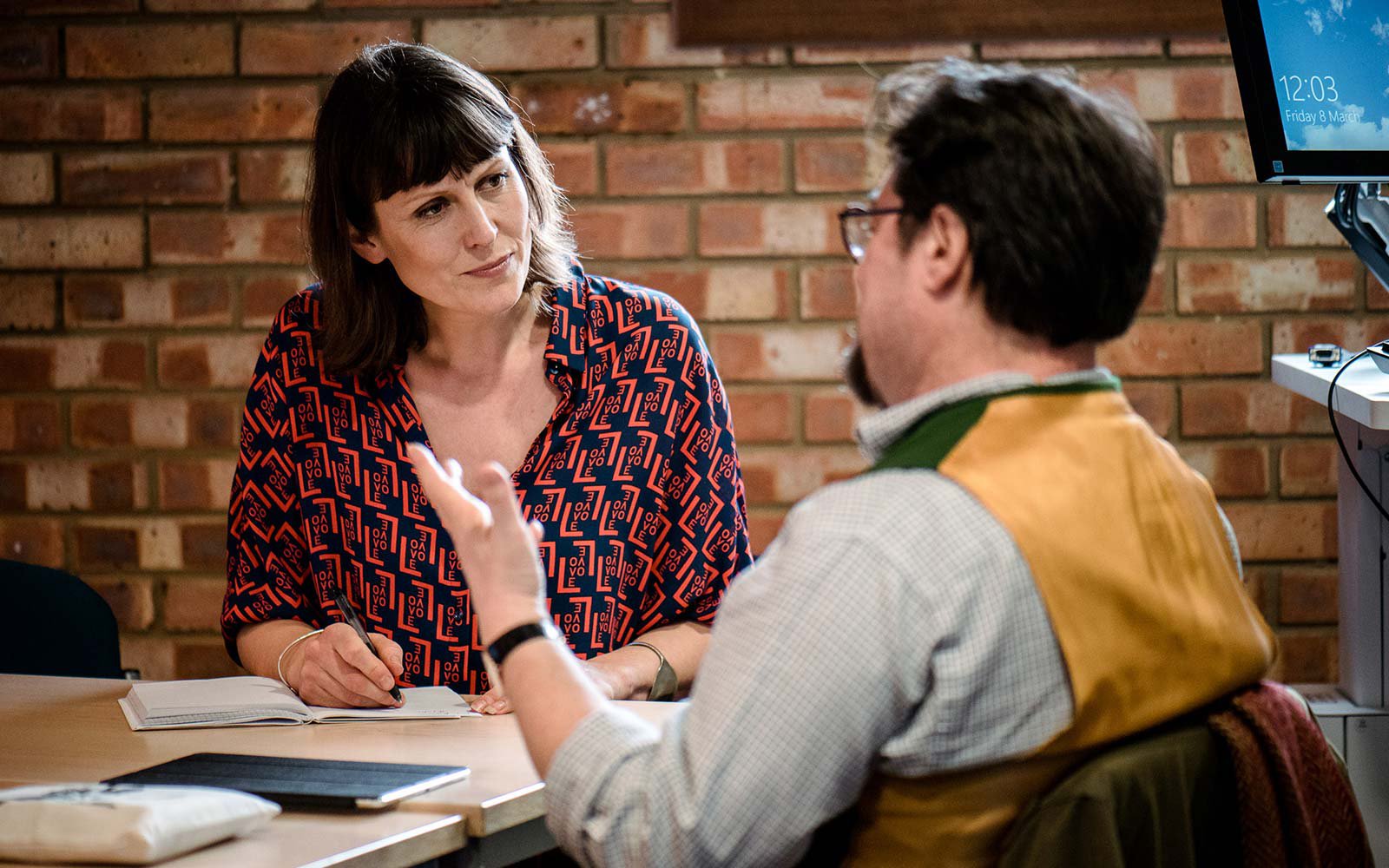 People talking at a desk