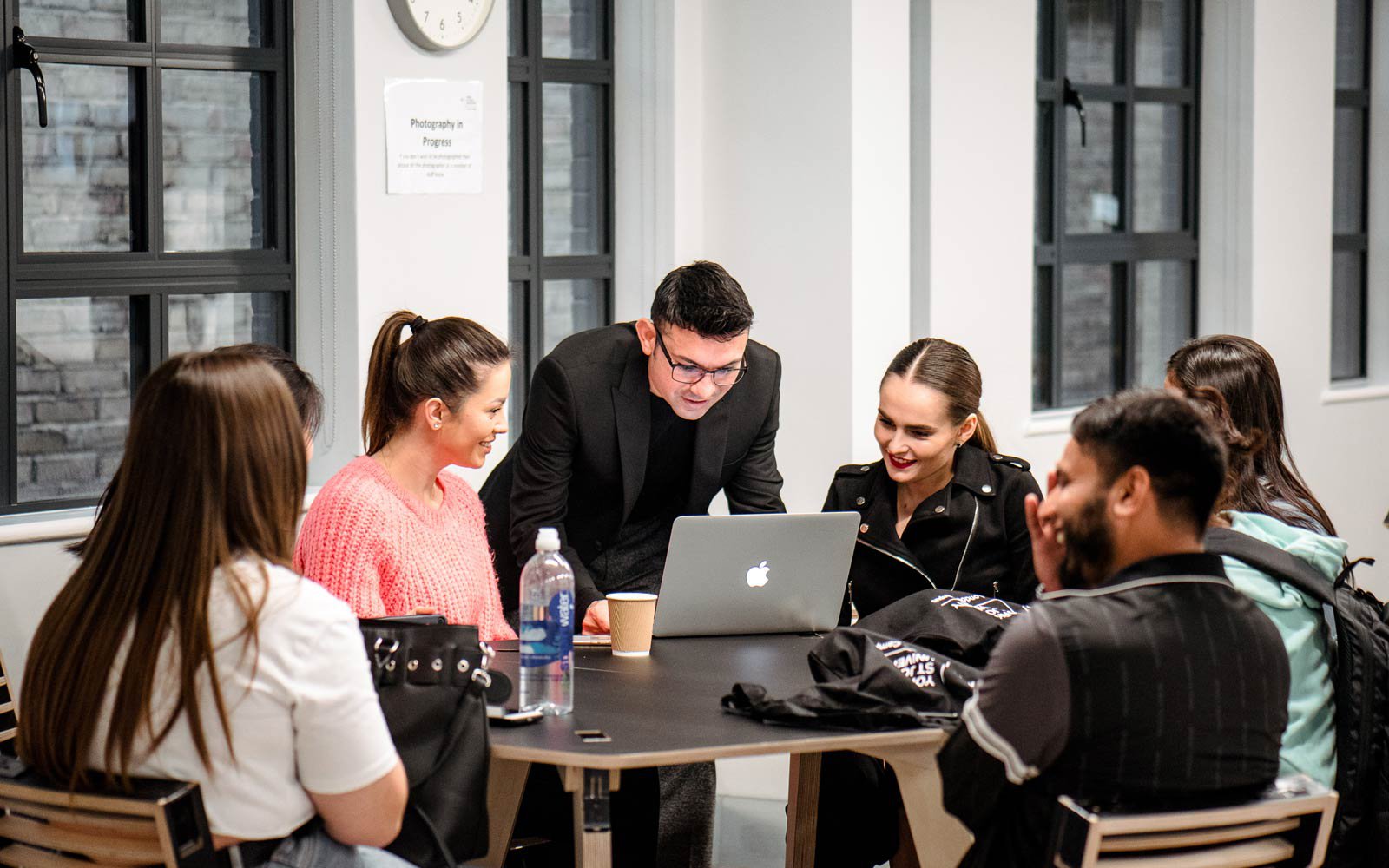 Group of students talking with their tutor