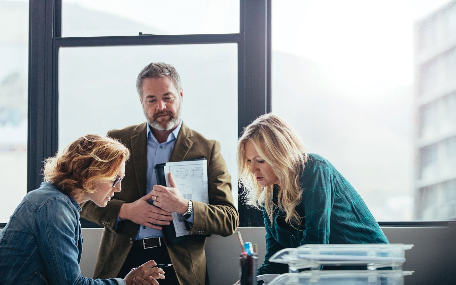 three people working on a project together