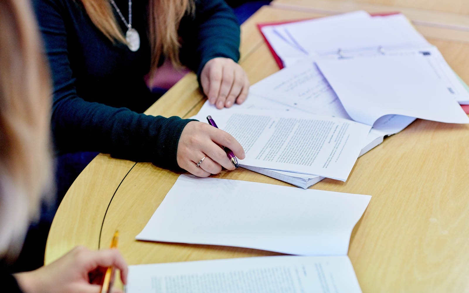 Notes and paper on table in front of student