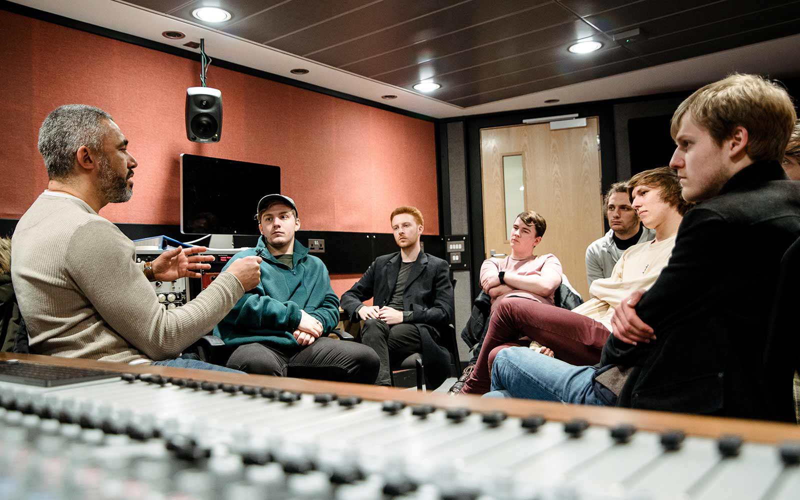 Students listening to guest lecturer in the music bunker