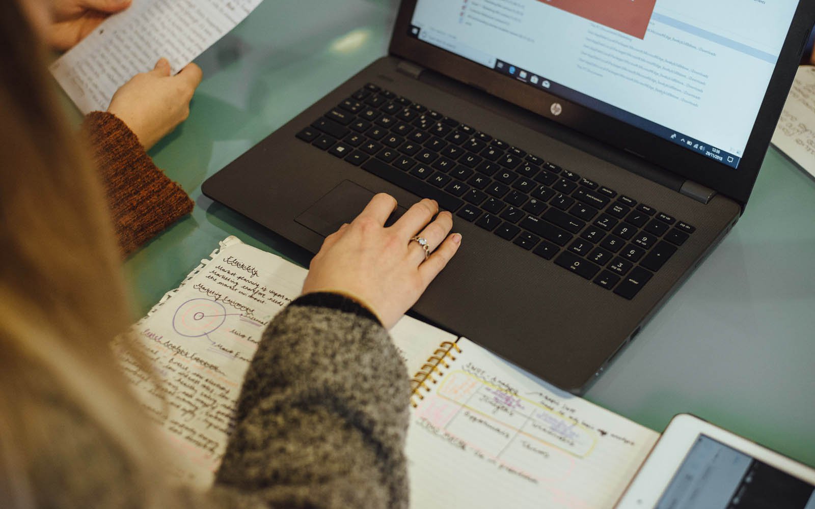 Student making notes and typing