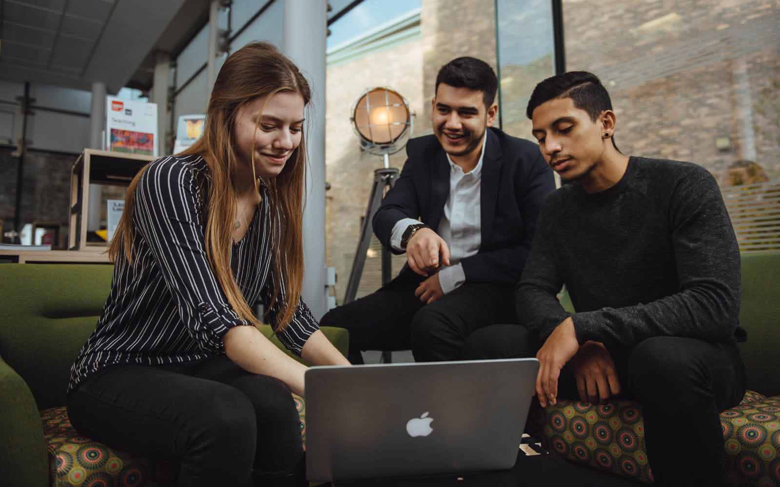 Students looking at laptop together