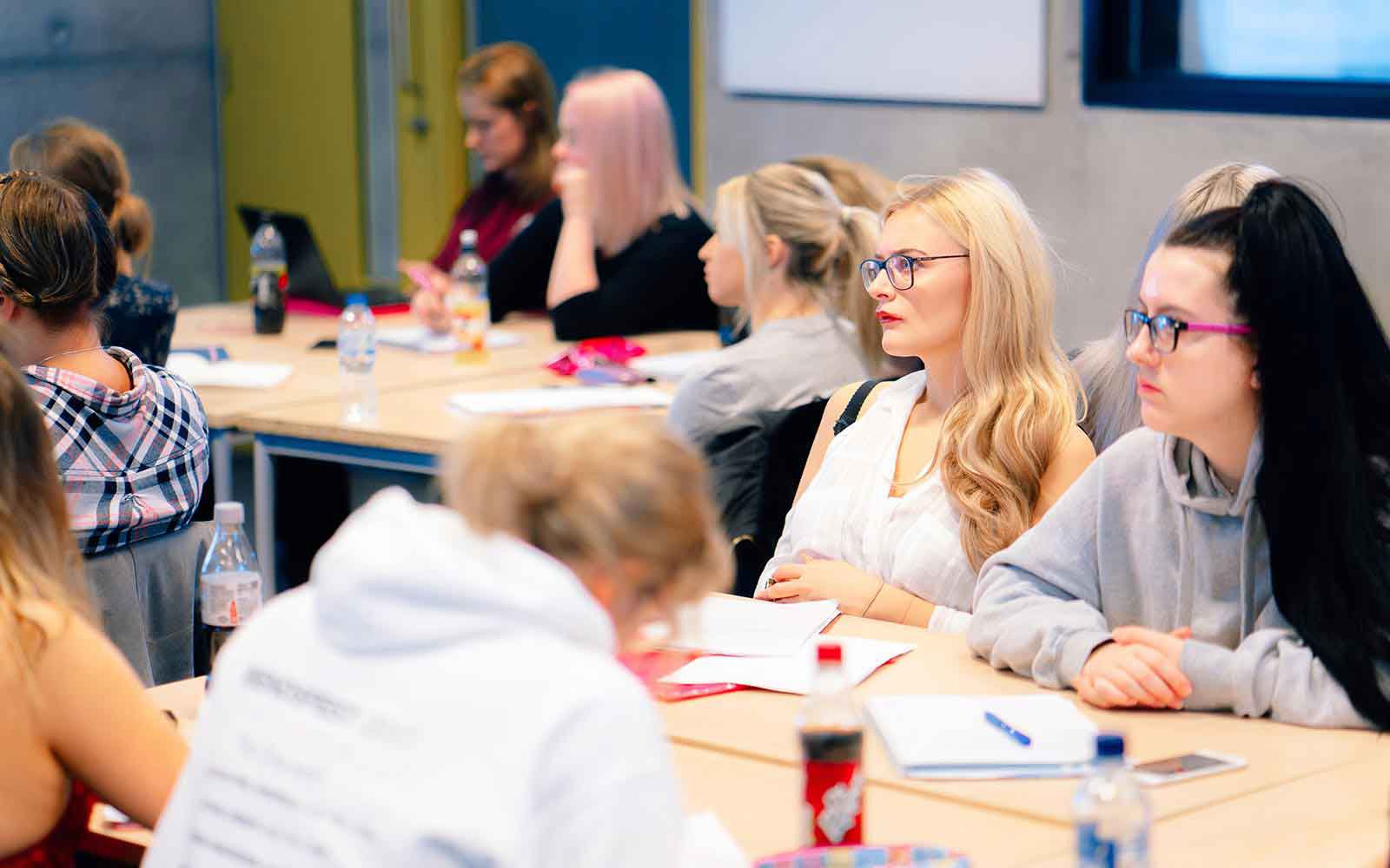 students in a lecture they are both wearing glasses