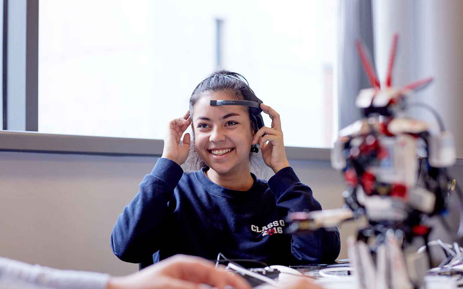 student using the equipment and smiling
