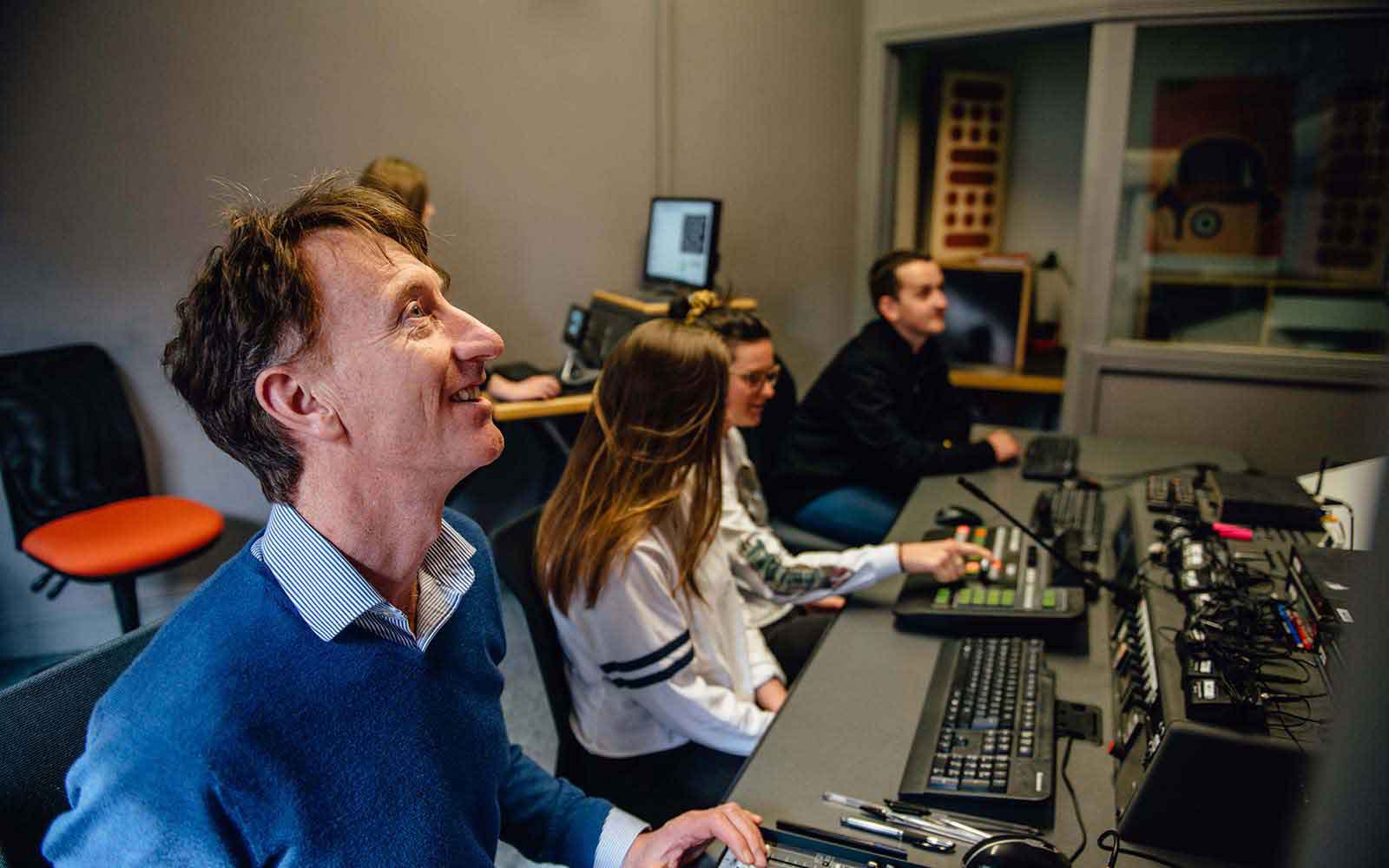 Media production lecturer and students using the equipment