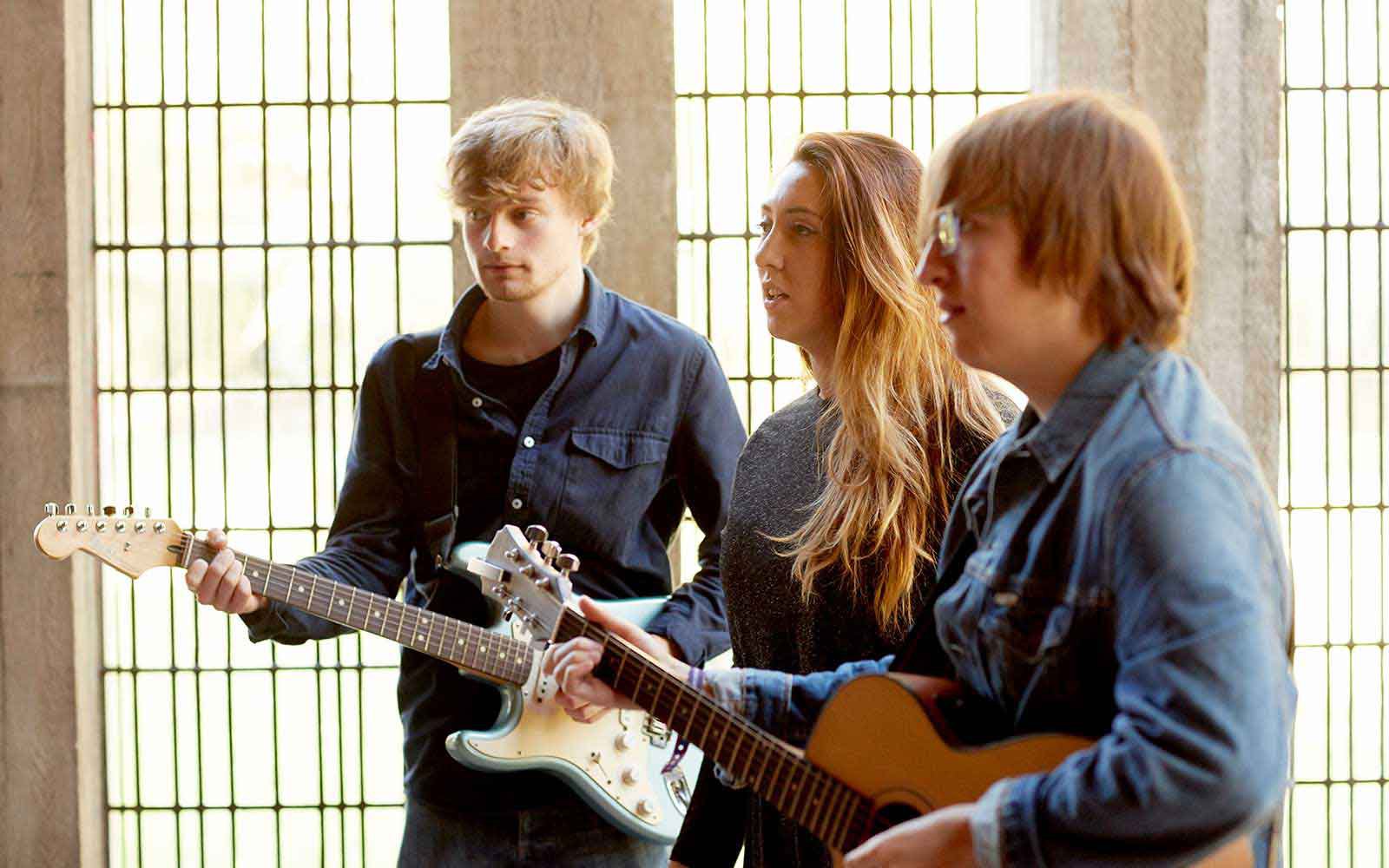 Three students performing in the chapel