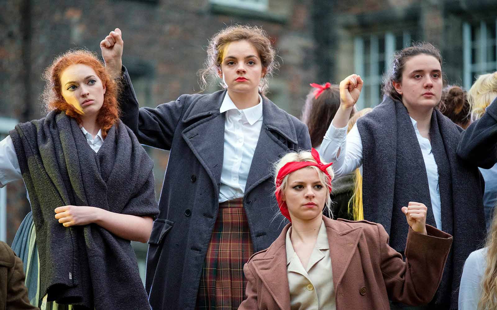 Four students performing, they are looking at the camera