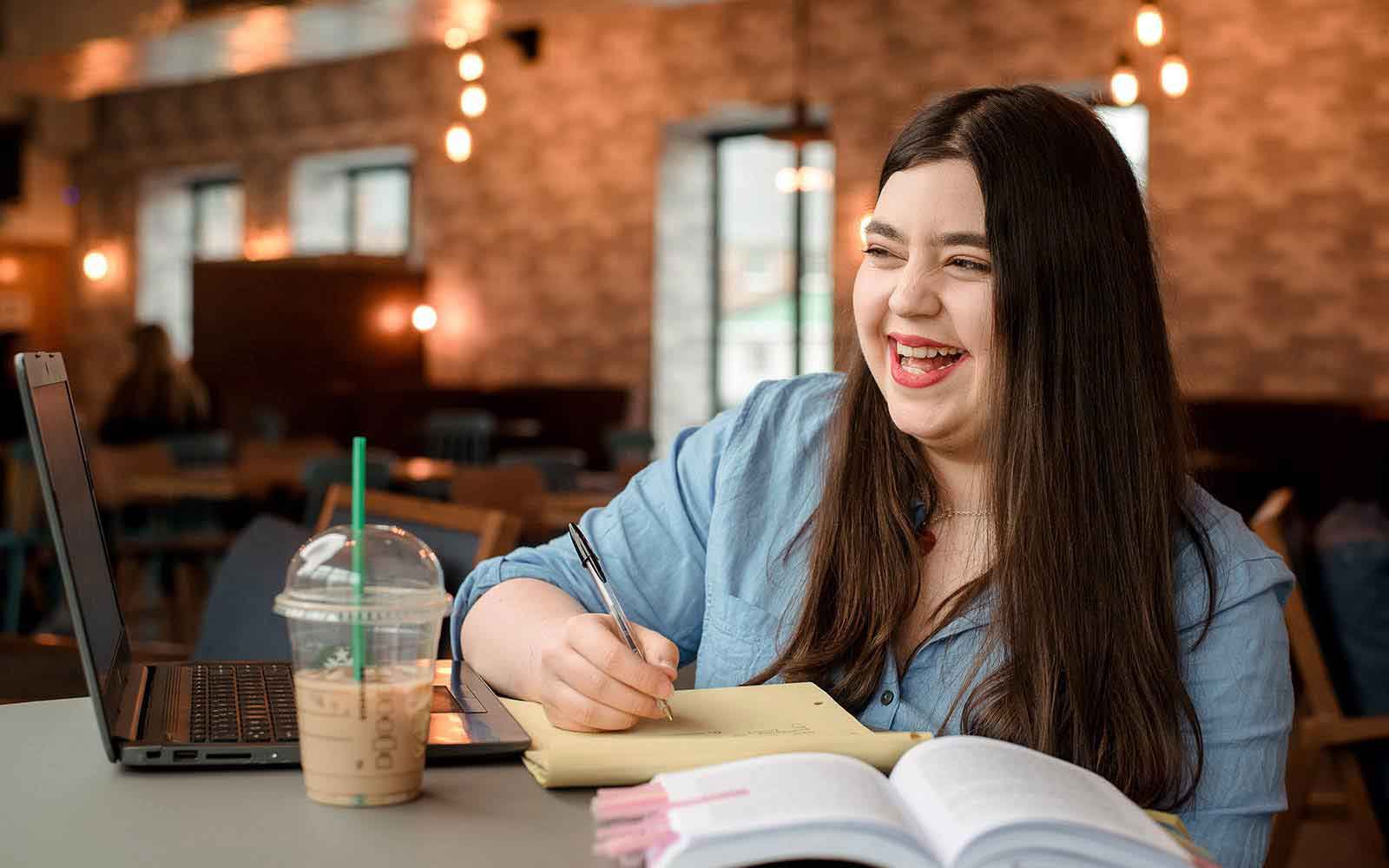student in the SU working she is smiling