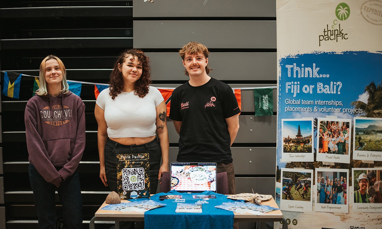 Think Fiji stand with three representatives smiling at camera at Global opportunities fair 