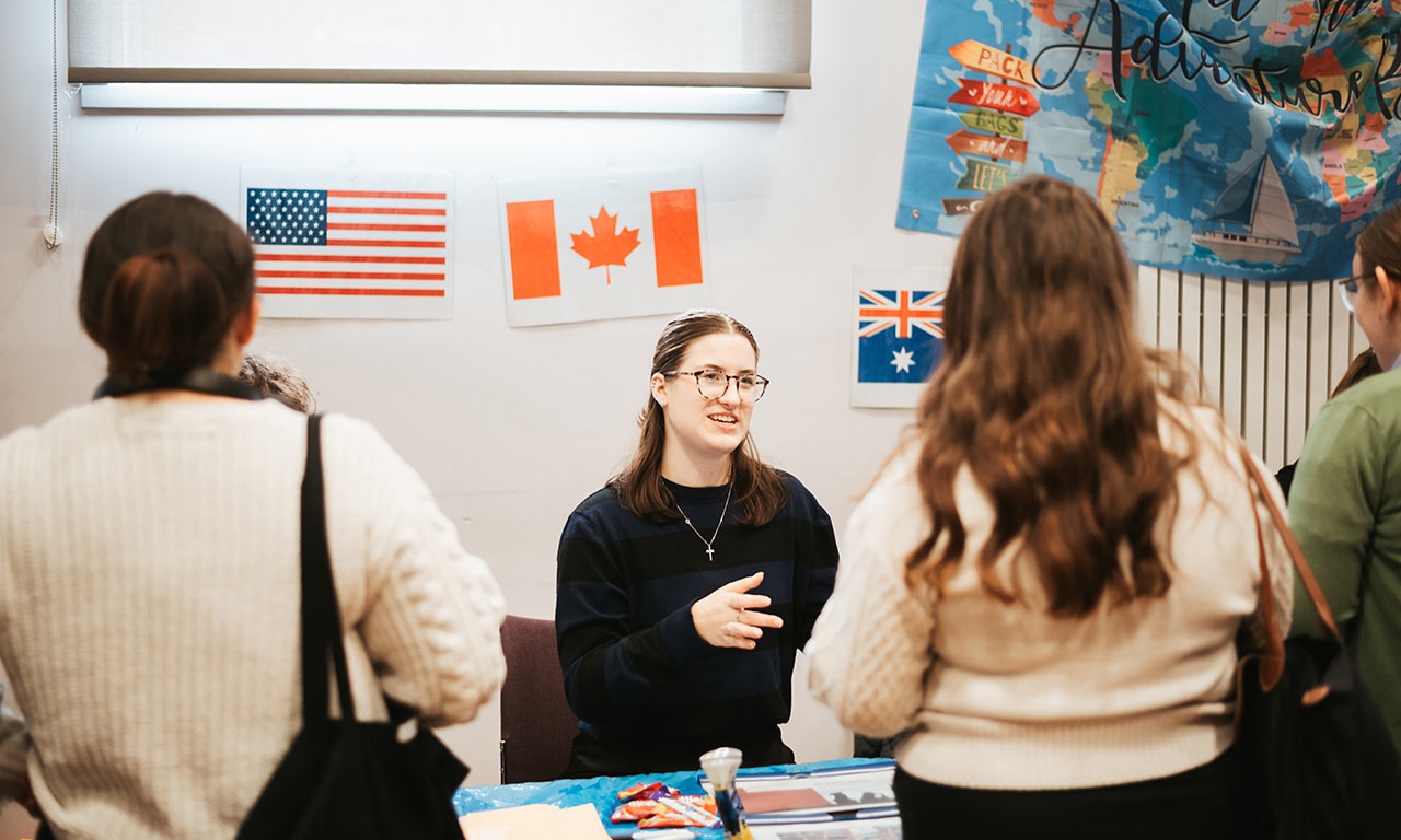 Students talking about global opportunities with staff member 